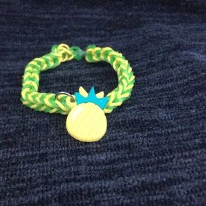 A yellow and green bracelet with a pineapple charm